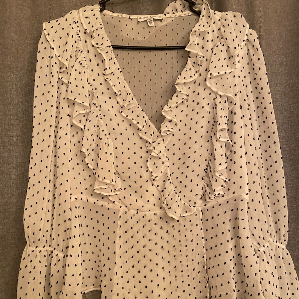 Women’s white ruffled blouse.